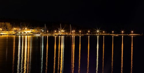Boats on calm sea at night