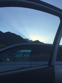Cars on road against sky seen through car windshield