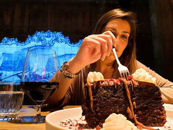 Low angle view of woman eating dessert in restaurant