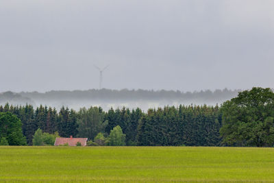 Scenic view of field against sky after the rain - wind turbine in the distance