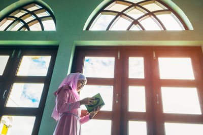 Woman looking through window