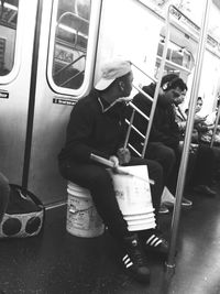 Side view of man sitting in bus