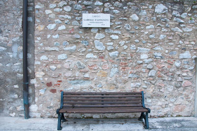 Text on bench against wall