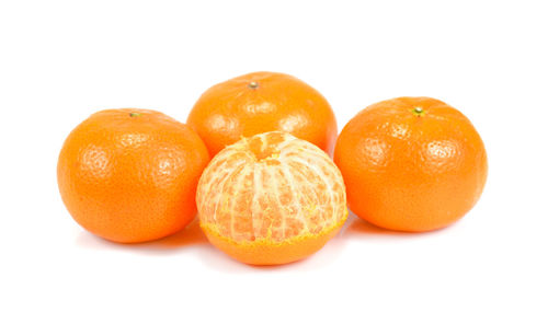 Close-up of oranges against white background