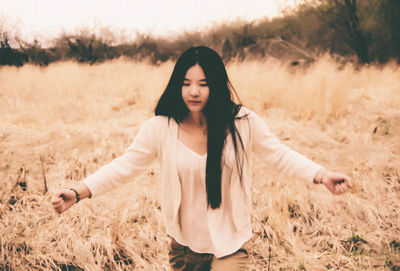 Full length of woman standing on field