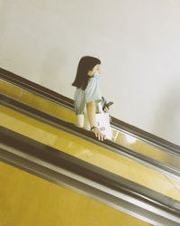 Low angle view of woman standing on staircase