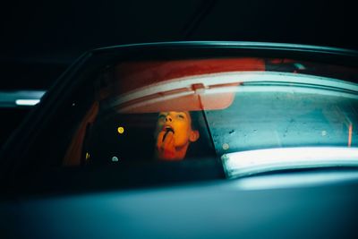 Portrait of man seen through car window