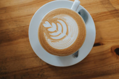 Close-up of coffee cup on wooden table