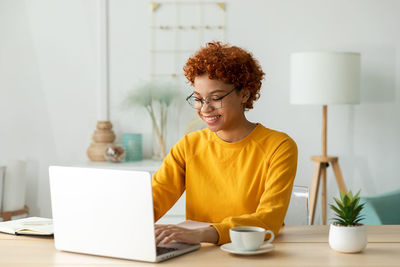 Young woman using laptop at home