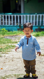 Portrait of cute boy standing outdoors