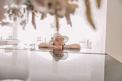 Portrait of young woman standing in a hotel lounge 