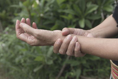 Cropped hands of woman with wrist pain