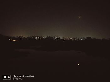 Illuminated city against sky at night