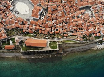 High angle view of canal amidst buildings in city