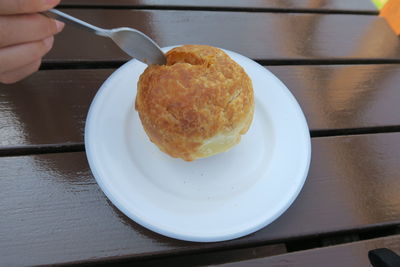 Close-up of hand holding food in plate