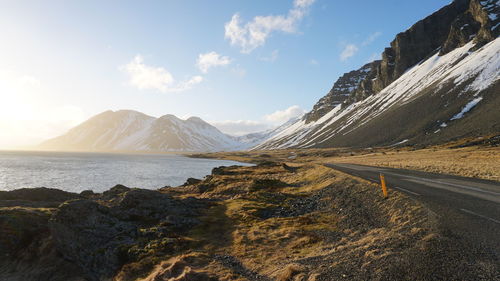 Scenic view of sea and mountains against sky