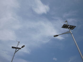 Low angle view of street lights against sky