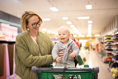 Portrait of young woman standing in store