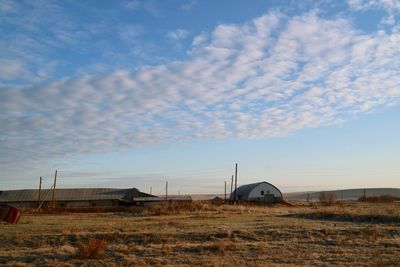 Built structure on field against sky