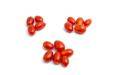 Close-up of tomatoes over white background