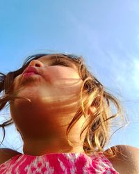 Close-up of girl against sky