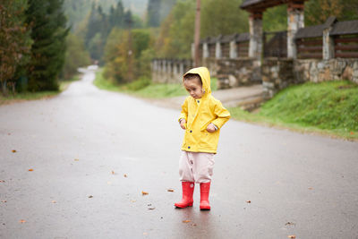 Full length of boy standing on road