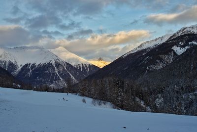 Scenic view of snow covered mountains against sky