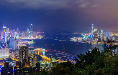 High angle view of illuminated buildings against sky at night