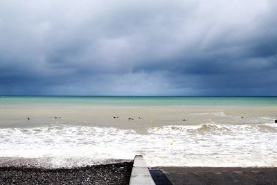 Scenic view of sea against cloudy sky