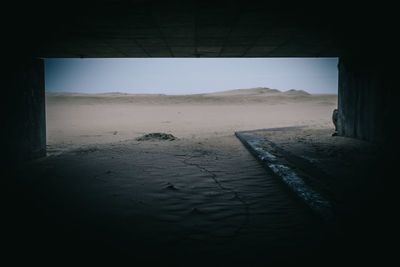 Scenic view of sand against clear sky