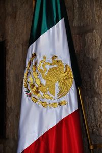 Close-up of mexican flag hanging on wall