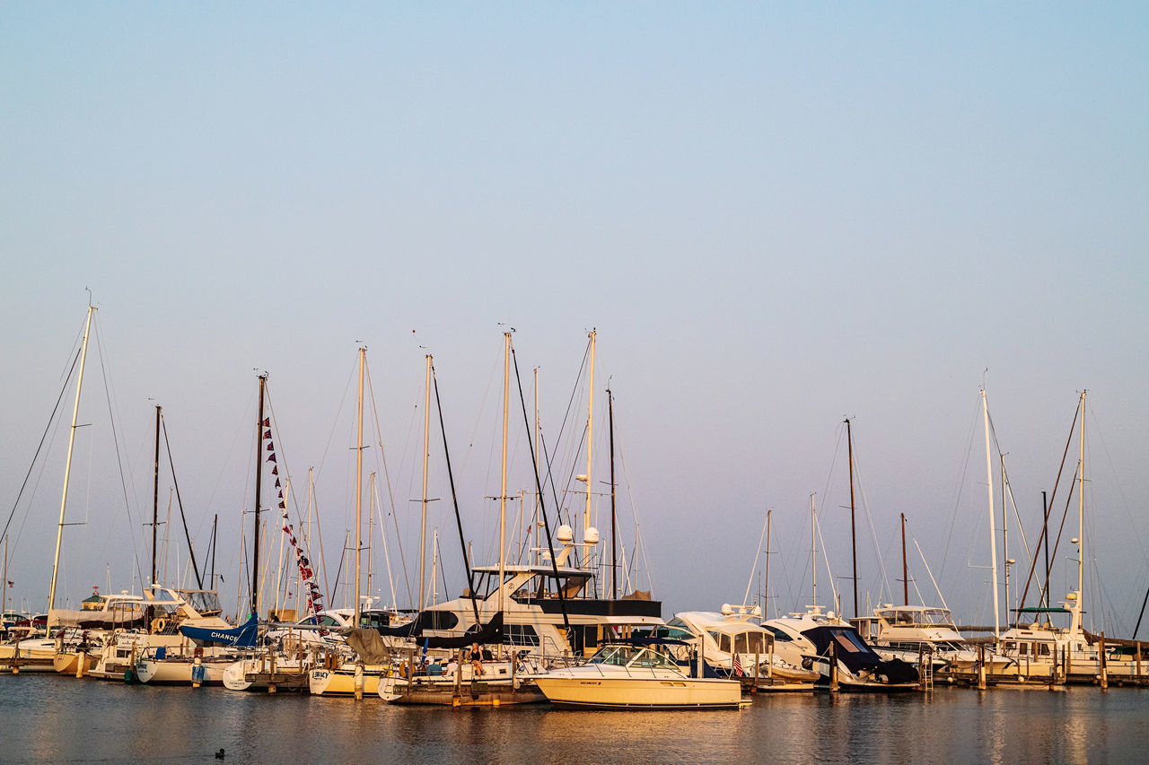 water, nautical vessel, sailboat, transportation, sea, mode of transportation, marina, pole, sky, harbor, mast, dock, vehicle, ship, boat, nature, no people, sailing, clear sky, bay, moored, port, copy space, travel, sailing ship, architecture, watercraft, tranquility, beauty in nature, outdoors, day, travel destinations, reflection, pier, yacht