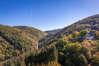 Scenic view of mountains against clear blue sky