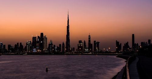 Modern buildings in city at sunset
