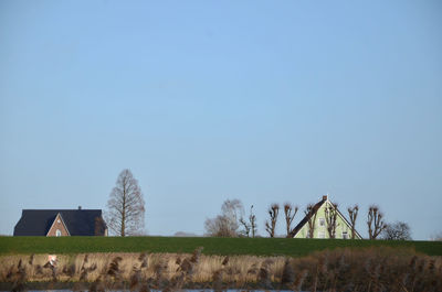 Barn on field against clear sky