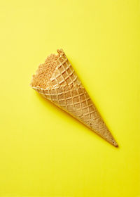 High angle view of leaf on yellow background
