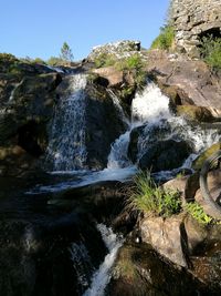 Scenic view of waterfall against clear sky