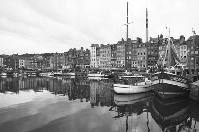 Boats in harbor with buildings in background