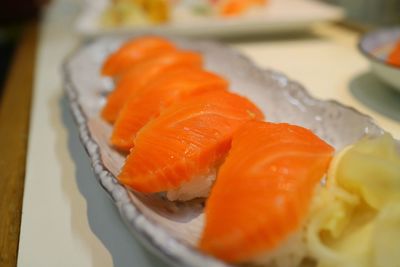 Close-up of salmon sushi served in plate.