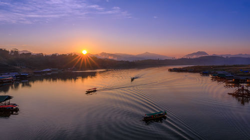 Landscape view morning the sunrise and long tail boat sailing in the river at mon bridge viewpoint 