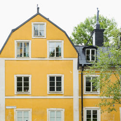 Low angle view of yellow building against sky