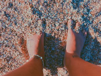 Low section of woman on sand at beach