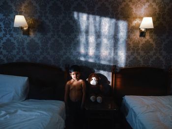 Two people sitting on bed in bedroom