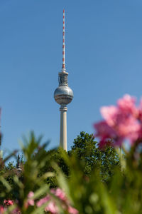 Low angle view of communications tower against sky
