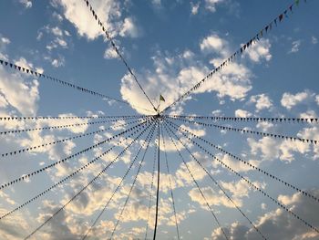 Low angle view of chain swing ride against sky