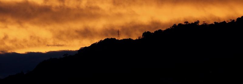 Silhouette of mountain against sky at sunset