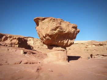 Rock formations against clear blue sky