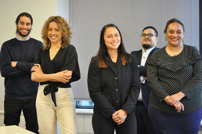 Portrait of business colleagues stacking hands at office