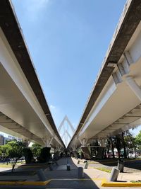 Low angle view of bridge against sky in city