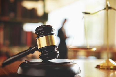 Close-up of gavel at desk in office